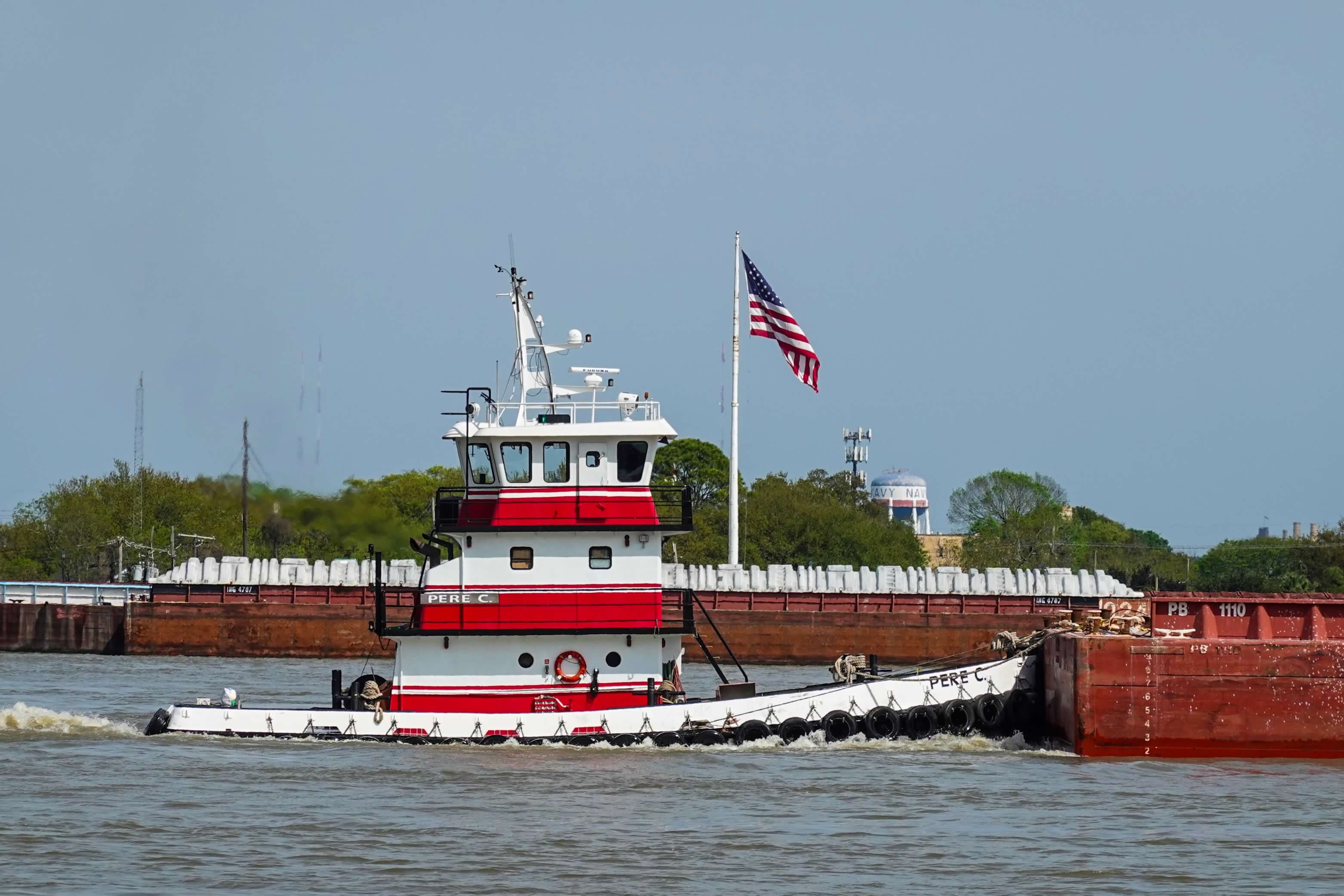 M/V Pere C pushing barges with the American flag flying